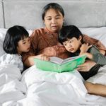 ethnic mother reading fairytale with kids